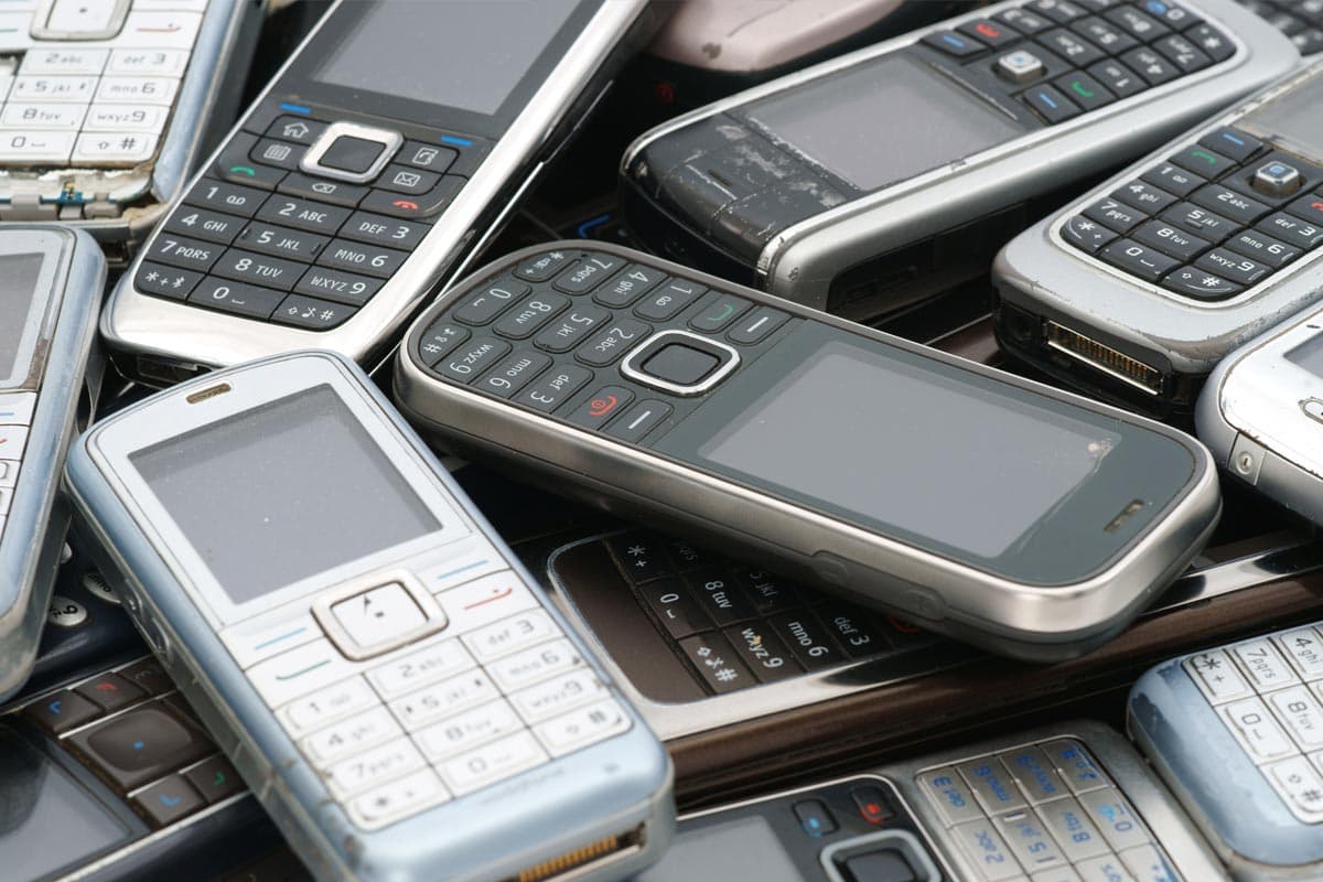 A pile of old, discarded cell phones.