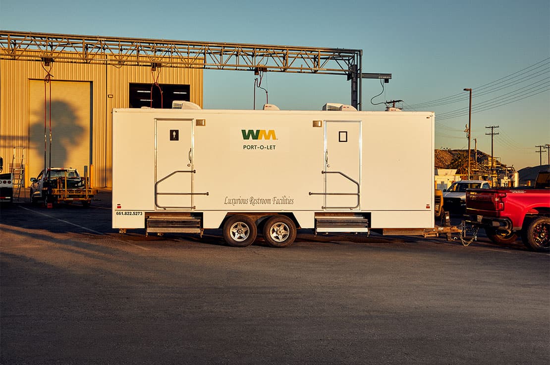 WM portable toilet and sanitary station on trailer attached to truck
